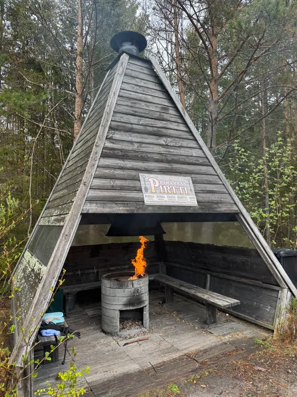 The wooden grill kota in the forest with the fire burning inside