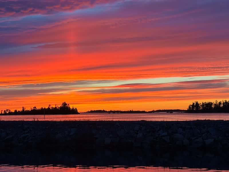 A night sky glowing red and orange above the skerries