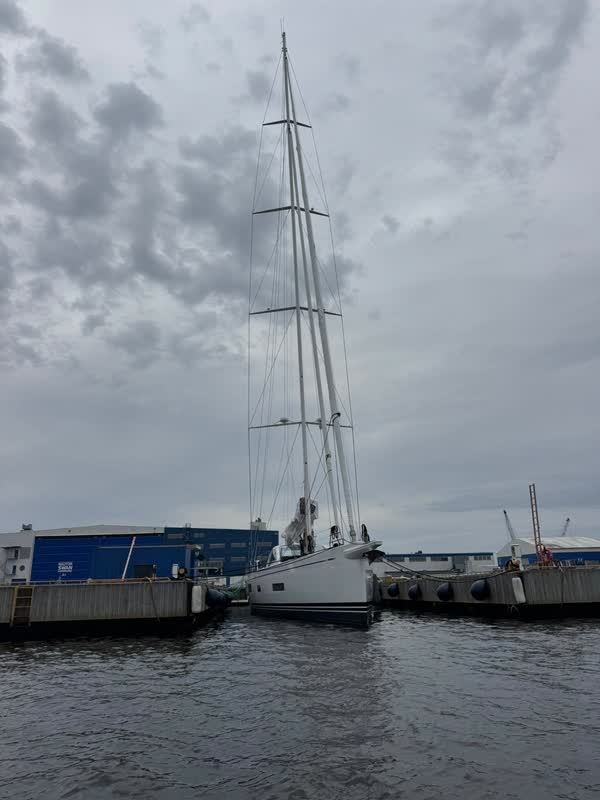 Tom Cruise’s Swan 108 lying at the quay of the Finnish Nautor Swan yard in Pietarsaari, the blue yard hall with the Nautor Swan sign behind her